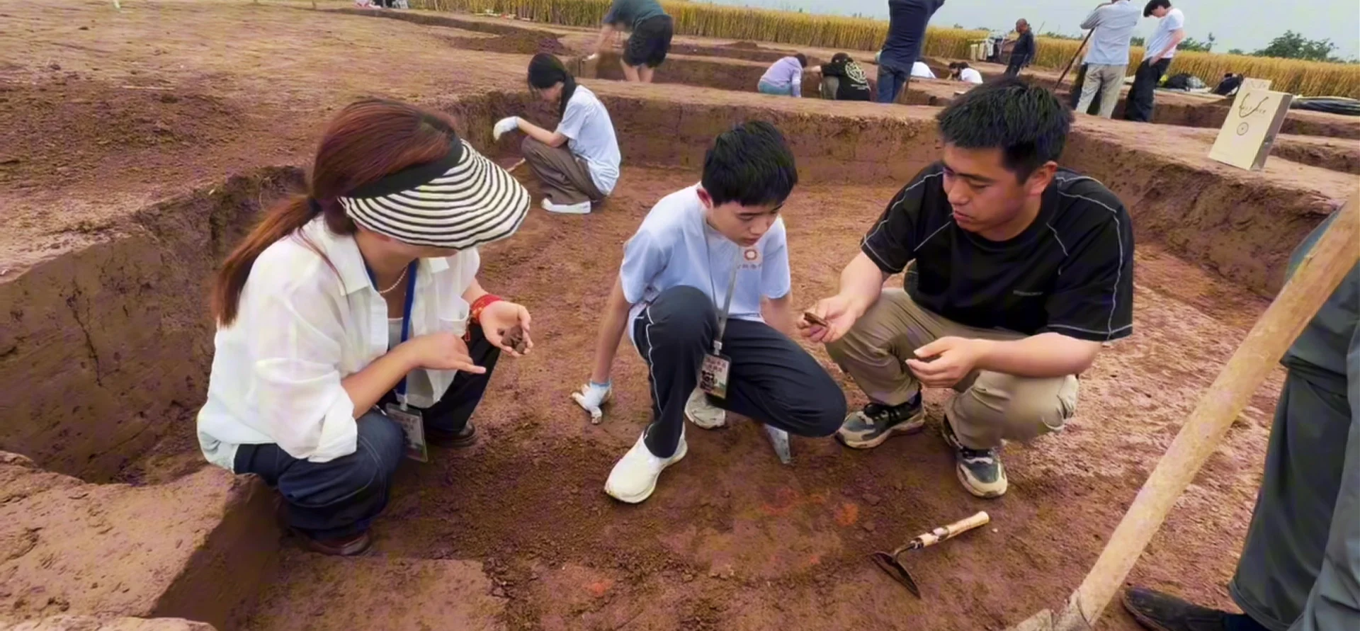 MCA students examining archaeological finds alongside a specialist